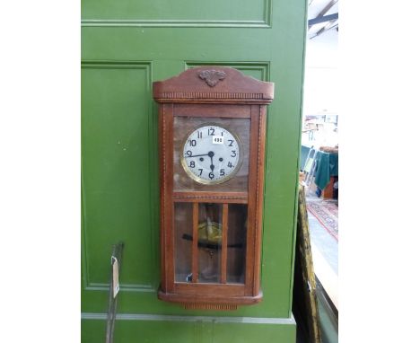 A 1930'S OAK CASED WALL CLOCK. 