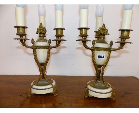 A PAIR OF ORMOLU AND WHITE MARBLE TRIPLE LIGHT TABLE TAMPS, EACH WITH THREE PINE CONES ON THE ARMS CLOSE TO THE OVOID MARBLE 