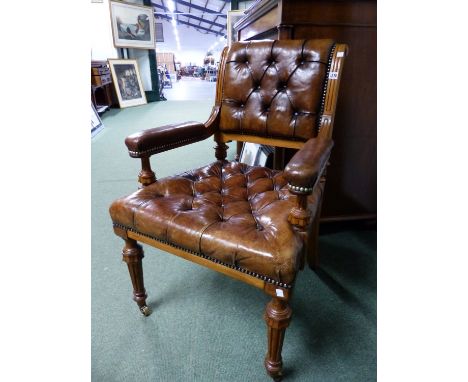 A 19th C. OAK ELBOW CHAIR, THE BACK AND SEAT BUTTON UPHOLSTERED IN LEATHER, THE FLUTED TAPERING CYLINDRICAL FRONT LEGS ON BRA