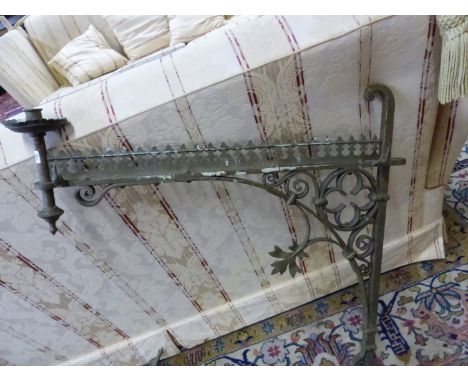 A PAIR OF ANTIQUE GOTHIC REVIVAL IRON CANDLESTICK BRACKETS, THE BAR BACK PLATES JOINED TO THE CANDLESTICK ARM BY WROUGHT IRON