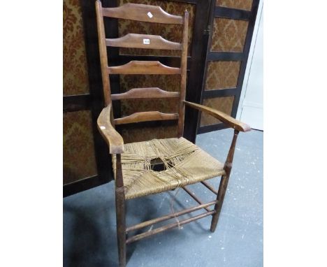 A LATE 19th/EARLY 20th C. CLISSETT LADDER BACKED ELBOW CHAIR WITH RUSH SEAT.`