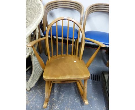 AN ERCOL HOOP BACKED ROCKING CHAIR, THE SIX STICK BACK ABOVE AND SADDLE SEAT FLANKED BY CURVED ARMS