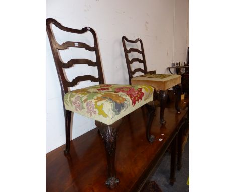 A PAIR OF GEORGE III MAHOGANY LADDER BACKED CHAIRS WITH FLORAL NEEDLE WORKED SEATS, CARVED WITH SHELLS AT THE KNEES OF THE CA