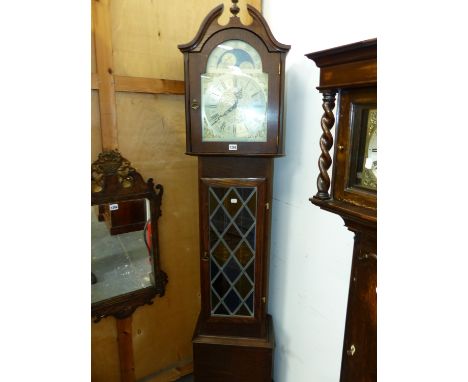 A WESTERN GERMAN OAK LONG CASED CLOCK, THE SILVER DIAL WITH A MOON PHASE ARC IN THE ARCH ABOVE A LEADED GLASS CASE DOOR.   H 