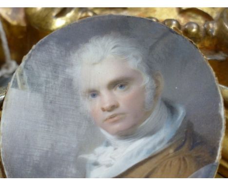 AN 18th C. WATERCOLOUR&nbsp; PORTRAIT MINIATURE OF AN ARTIST WITH BRUSH IN HAND, HE WEARS A BROWN JACKET, THE GILT WOOD FRAME