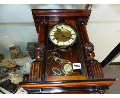 A WALL CLOCK COMPLETE WITH PENDULUM AND KEYS