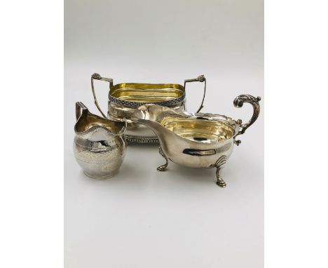 A GEORGIAN HALLMARKED SILVER SUGAR BASIN (MARKS RUBBED) WITH GILDED INNER. TOGETHER WITH AN ART DECO SILVER HALLMARKED SAUCE 