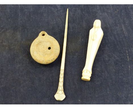 AN ANTIQUE AFRICAN IVORY PRAYING FIGURE, A IVORY HAIR STICK, AND A ROMAN OIL LAMP