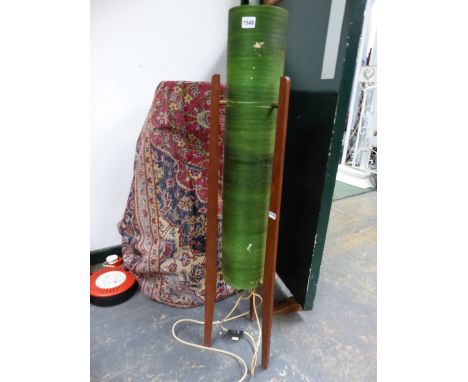 A 20th C. FLOOR STANDING "ROCKET"  LAMP, THE CYLINDRICAL GREEN SHADE SUPPORTED BY THREE MAHOGANY BAR LEGS.   H 106.5cms.