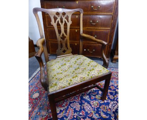 A GEORGE III MAHOGANY CHIPPENDALE STYLE NEOGOTHIC ELBOW CHAIR, THE DROP IN SEAT WITH FLOWER CENTRED DIAMOND DIAPER ON A BEIGE