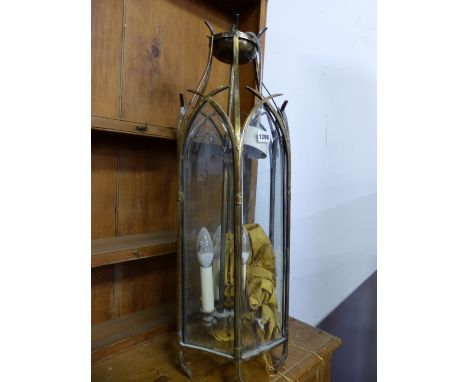 A GLAZED BRASS HEXAGONAL THREE LIGHT LANTERN, EACH GLASS PANEL WITH GOTHIC ARCHED TOP. H 79cms.