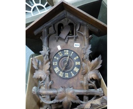 A BLACK FOREST STAINED PINE CUCKOO CLOCK, THE CHALET HOUSING CRESTED BY A STAGS HEAD FLANKED BY VINE LEAVES, THE DIAL WITH WH