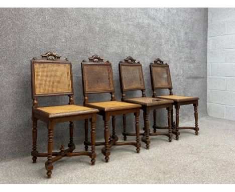 A set of four 19th century French oak hall or dining chairs each having a straight moulded top rail with a carved openwork cr