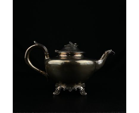 A 19th century English hallmarked silver teapot with leaf and bud finial and squat bulbous body on scrolling feet with London
