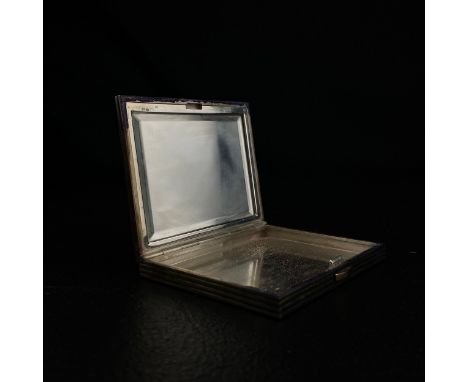 An early 20th century hallmarked .925 silver compact of rectangular form with a hinged engine turned lid and base with a reed