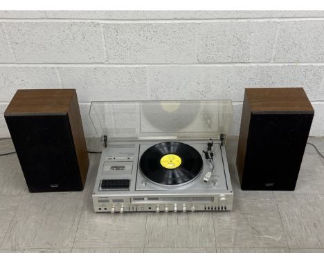 A vintage Toshiba record player with integrated tape deck and a pair of matching speakers. 