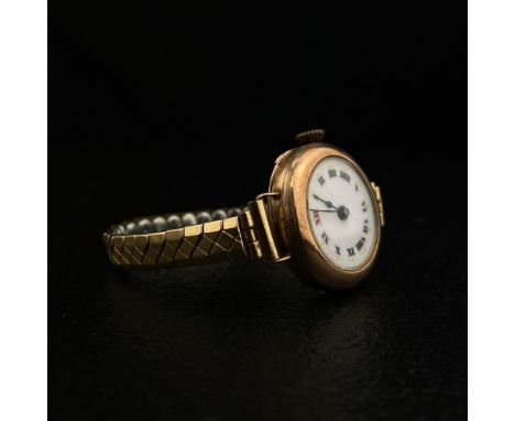 A 20th century Swiss made ladies wristwatch having a white enamelled dial bearing Roman numerals in a hallmarked 9ct rose gol
