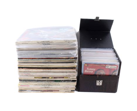 A collection of assorted vintage vinyl records. Including two boxes of comedy, soundtrack, some Beach Boys plus a box of 7 in