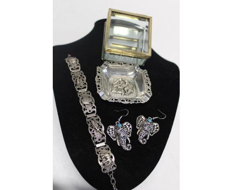 A glass trinket box and a selection of white metal items 