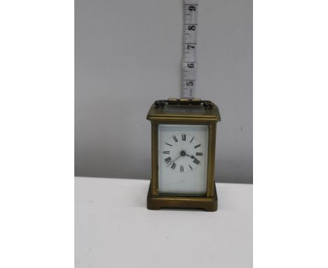 A brass and ceramic dial carriage clock 