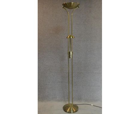 A floor standing uplighter with reading light. H.184cm 