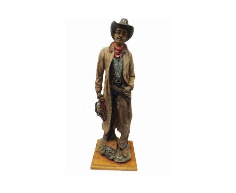 Figure of a cowboy holding a lamp and some rope, on an oak woodbase. Good condition, Height: 510mm