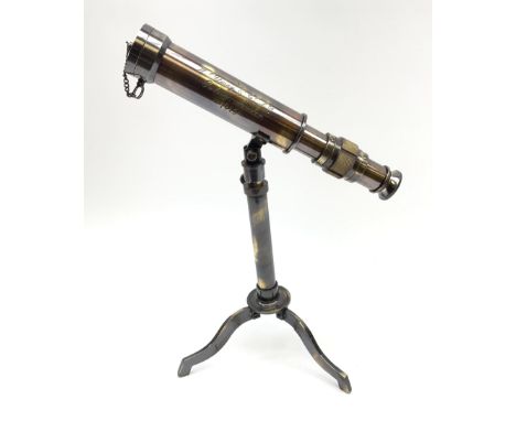 A small brass telescope mounted on an extending tripod base with folding feet, inscribed W Ottway &amp; Co Ltd, Ealing London