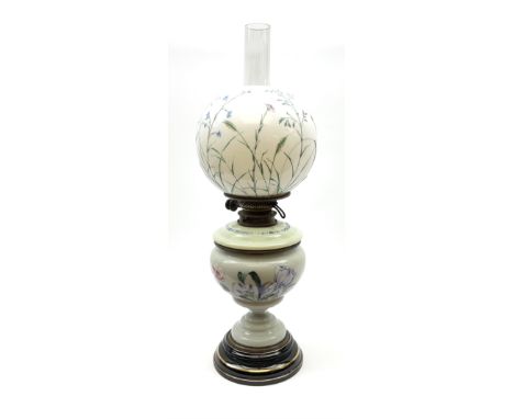 A Victorian oil lamp, with opaque glass reservoir hand painted with flowers beneath a Hinks burner and supporting a globular 