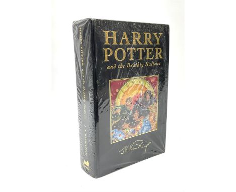 First Edition 'Harry Potter and the Deathly Hallows' by J.K. Rowling, partially sealed in plastic wrapper