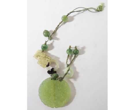 A Chinese Carved Jade Roundel and adornments, roundel 46mm diam. 