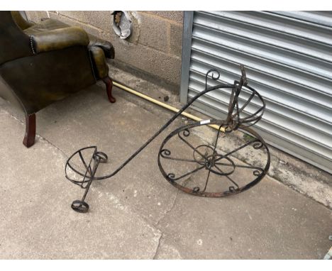 Metal outdoor penny farthing planter measures approx 29 inches tall by 36 long 