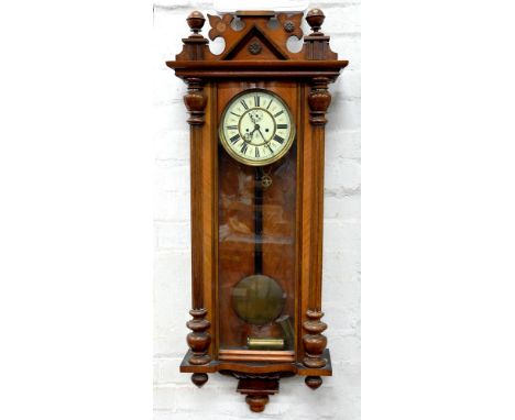 A WALNUT VIENNA WALL CLOCK BY GUSTAV BECKER WITH PRIMROSE ENAMEL DIAL AND TWO BRASS SLEEVED WEIGHTS, 110CM H
