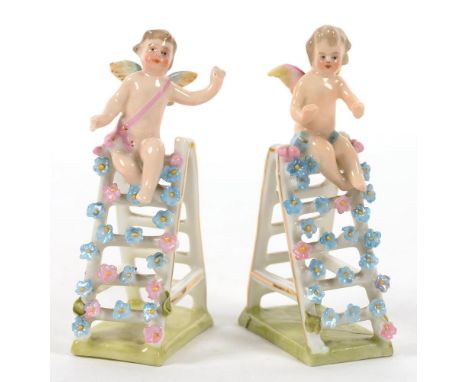 A PAIR OF GERMAN PORCELAIN MINIATURE FIGURES OF PUTTO ON A STEP LADDER, 9CM H, LATE 19TH C