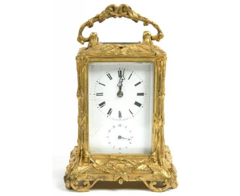 AN ORNATE CAST BRASS CARRIAGE CLOCK, THE ENAMEL MASK DIAL WITH ALARM DIAL, BELL STRIKING MOVEMENT WITH PLATFORM ESCAPEMENT IN