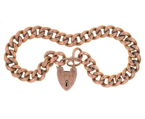 AN ENGRAVED 9CT GOLD CURB LINK BRACELET WITH PADLOCK CLASP, 16.5G++LIGHT WEAR CONSISTENT WITH AGE 