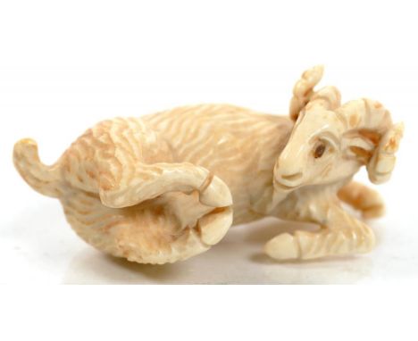 A JAPANESE IVORY NETSUKE IN THE FORM OF A RAM, 4CM L, SIGNED, EARLY 20TH C