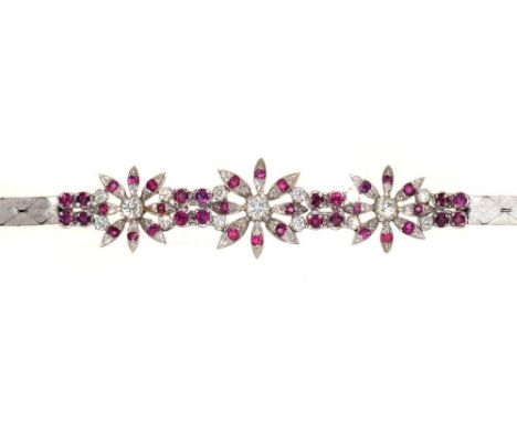 A RUBY AND DIAMOND BRACELET, OF FLORAL DESIGN, IN 18CT WHITE GOLD, 23G++IN GOOD CONDITION