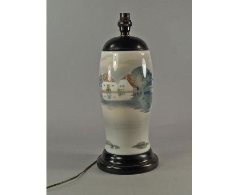 A Royal Copenhagen porcelain lamp base, 20th century, painted with continuous Danish landscape and sea within wooden top and 