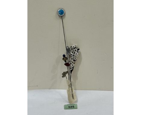 Five hatpins to include an example by Charles Horner of Shamrock form and another in silver and guilloche enamel.