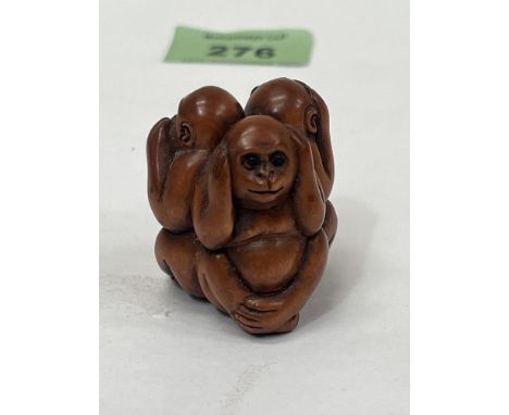 A Japanese carved boxwood three wise monkeys netsuke. 1½" high.