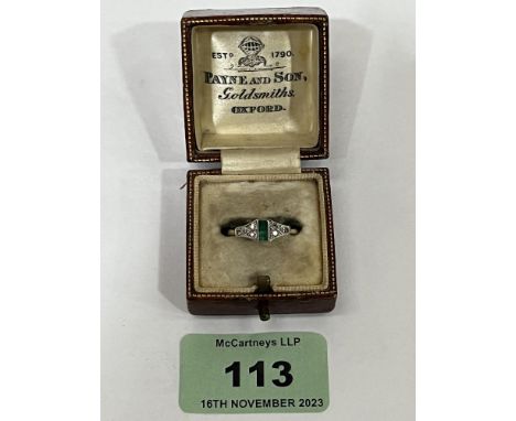 An Art - Deco style emerald and diamond ring. In gold marked 18ct. 3g gross. Size N. Boxed.