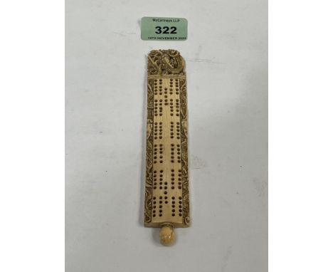 A 19th century carved bone cribbage board. 6½" long.