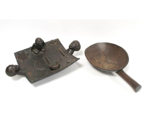 African carved hardwood divination dish of rectangular form with twin mask head handles, surmounted by a seated figure and bo