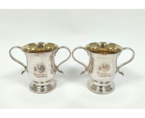 Pair of early Sheffield plated two-handled cups with loop handles, crested, on inset mahogany bases, by Morton & Co, c1765. H