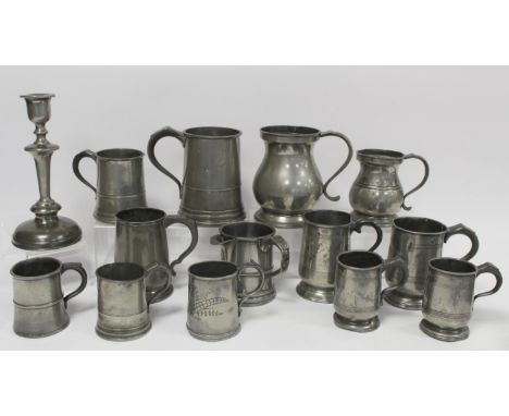 Collection of thirteen antique pewter tankards of various size, the largest 16cm high; also a pewter candlestick, 24cm high.&