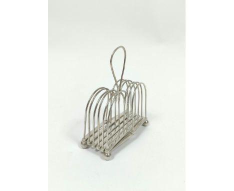 Rare silver folding toast rack, for six varying slices, with loop handle, the base stamped 'R C &amp; Co patent', crested, on