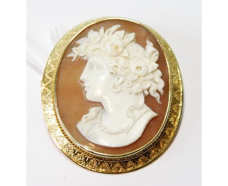 Victorian oval cameo brooch with female portrait in gold engraved mount, probably 15ct, 56mm x 48mm.