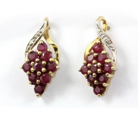 A pair of 9ct yellow gold (stamped 375) ruby and diamond set earrings.