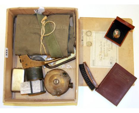 A box of mixed First and Second World War militaria including three trench stoves, button guard etc.