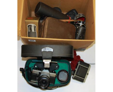 A Praktica single lens reflex camera, together with a group of lenses and photographic equipment.